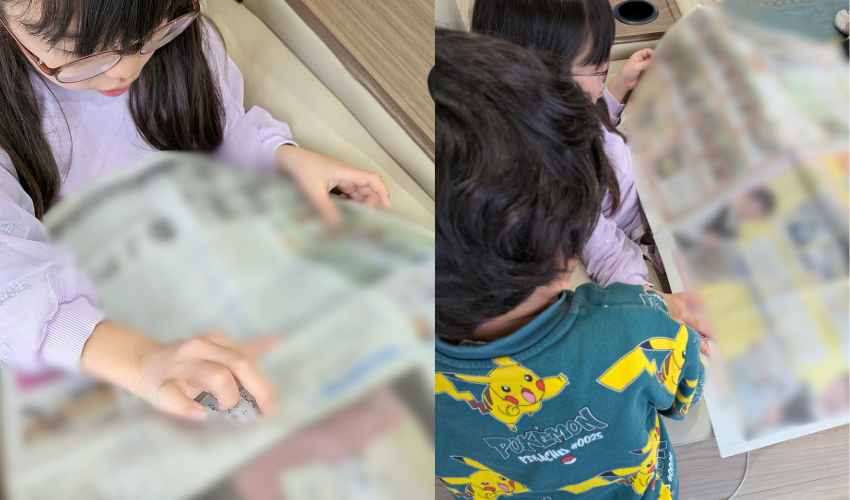 朝日小学生新聞を姉弟で読んでいる写真